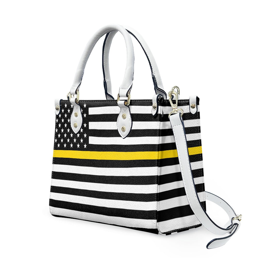 [Brand] handbag featuring American flag with yellow stripe, strap.