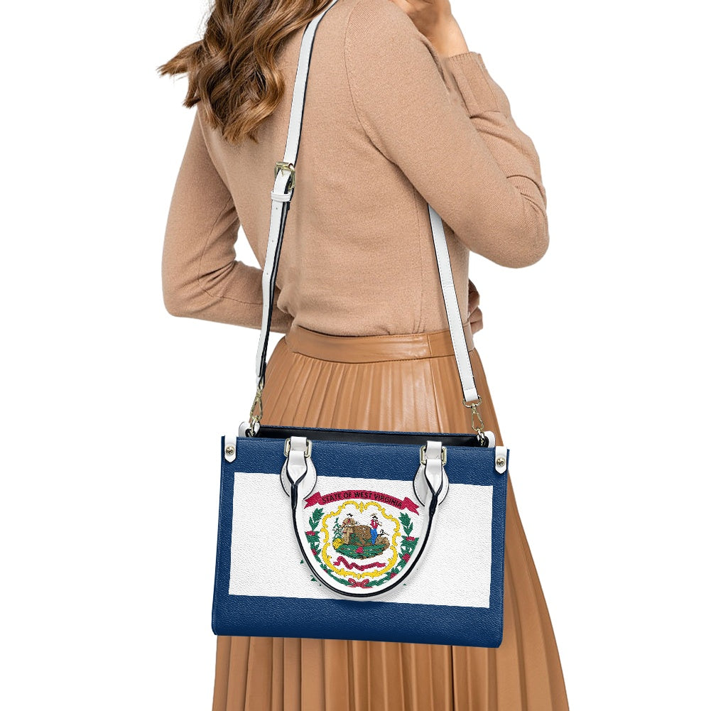Female holding [Brand] handbag with West Virginia flag design.