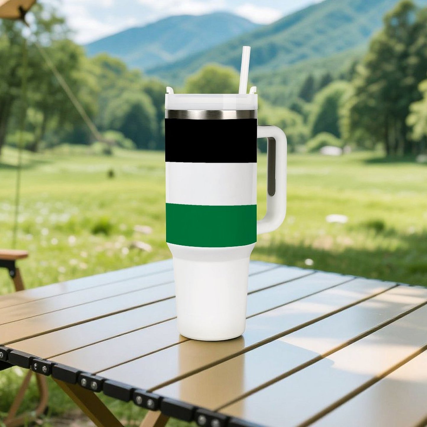 [Brand] insulated tumbler with straw on outdoor table, mountains background.