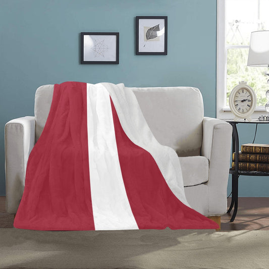 Cozy red and white [Luv My Flag] blanket on couch.