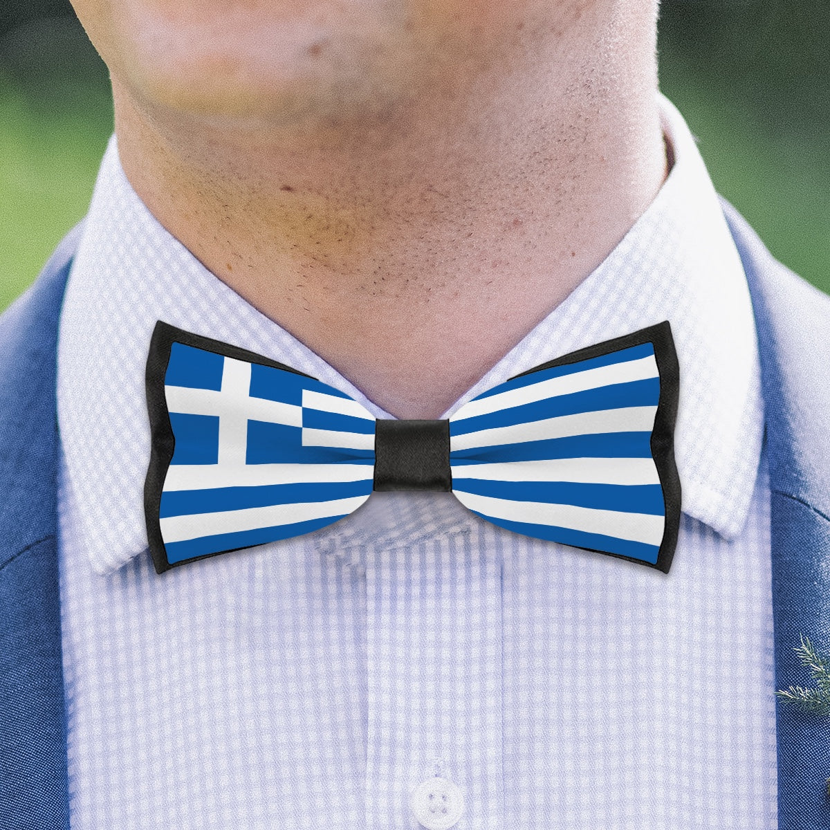 Man wearing [Brand] bow tie with Greek flag design.