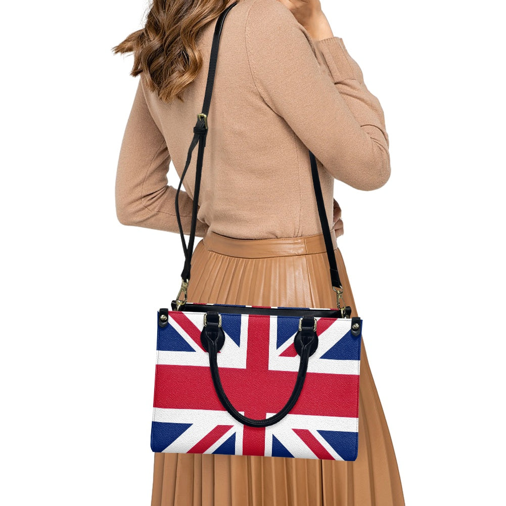 Woman carrying a [Brand] Union Jack handbag, wearing brown outfit.