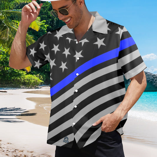 A man wearing [Brand] patriotic shirt on tropical beach.