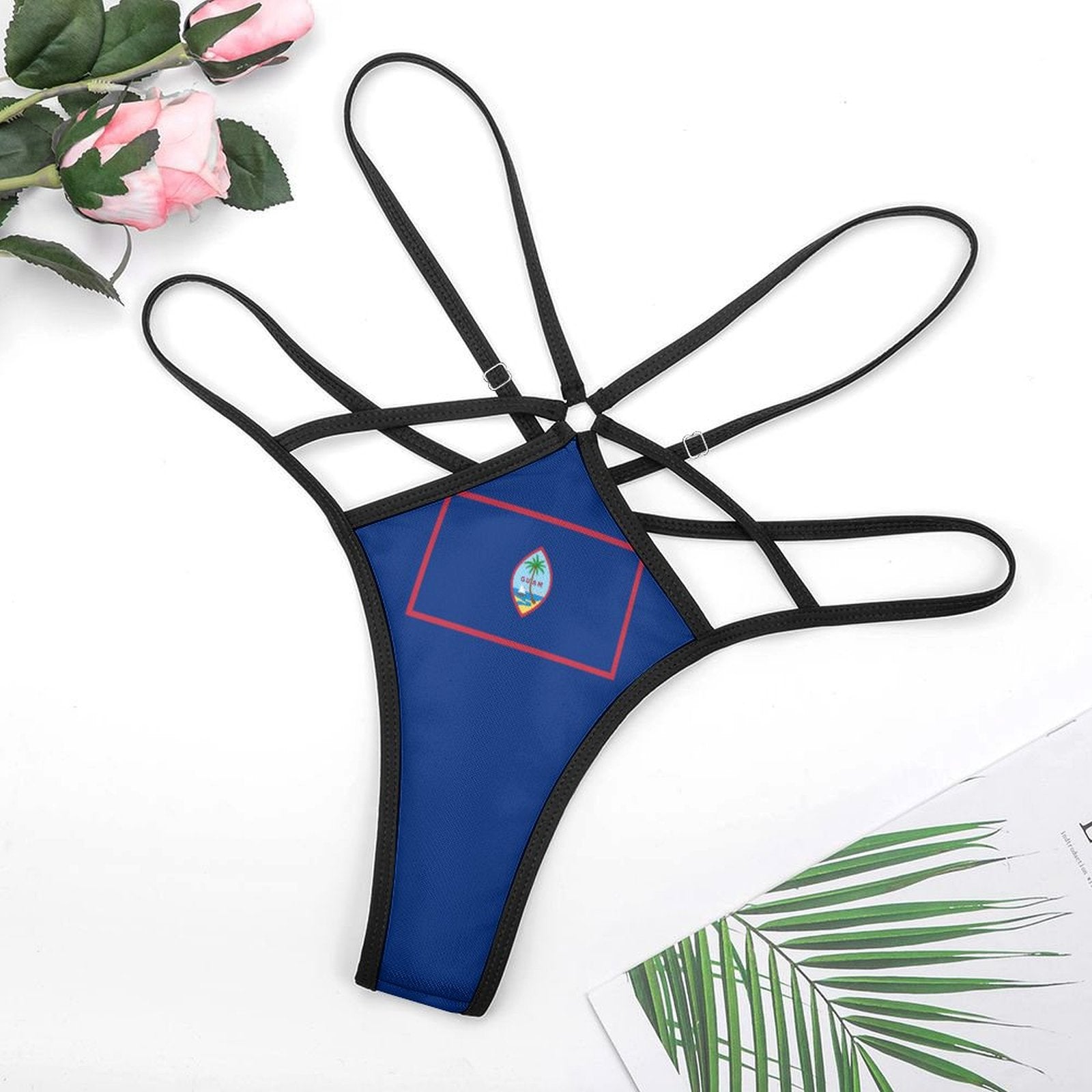 Blue [Brand] strappy bikini bottom with floral and leaf accents.