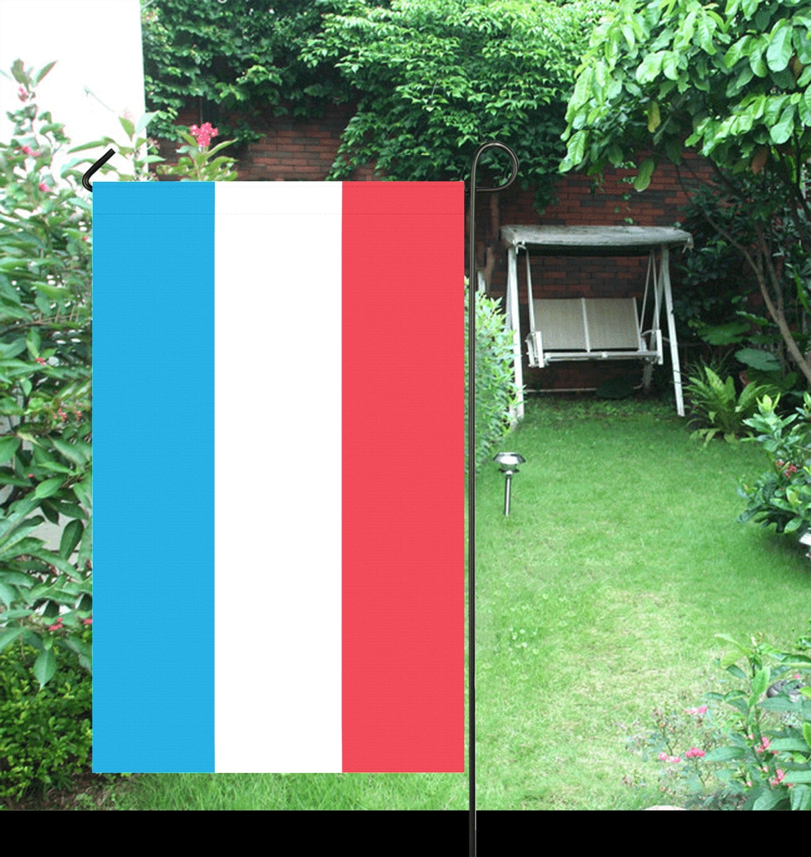 Luv My Flag banner displayed in a lush green garden.