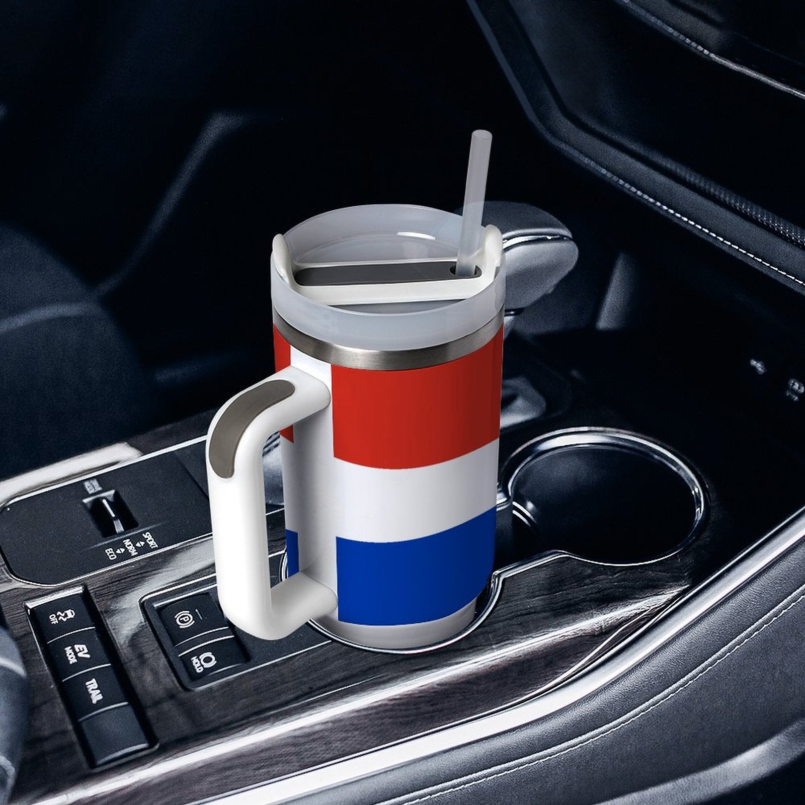 [Brand] mug with straw sits in car cup holder.