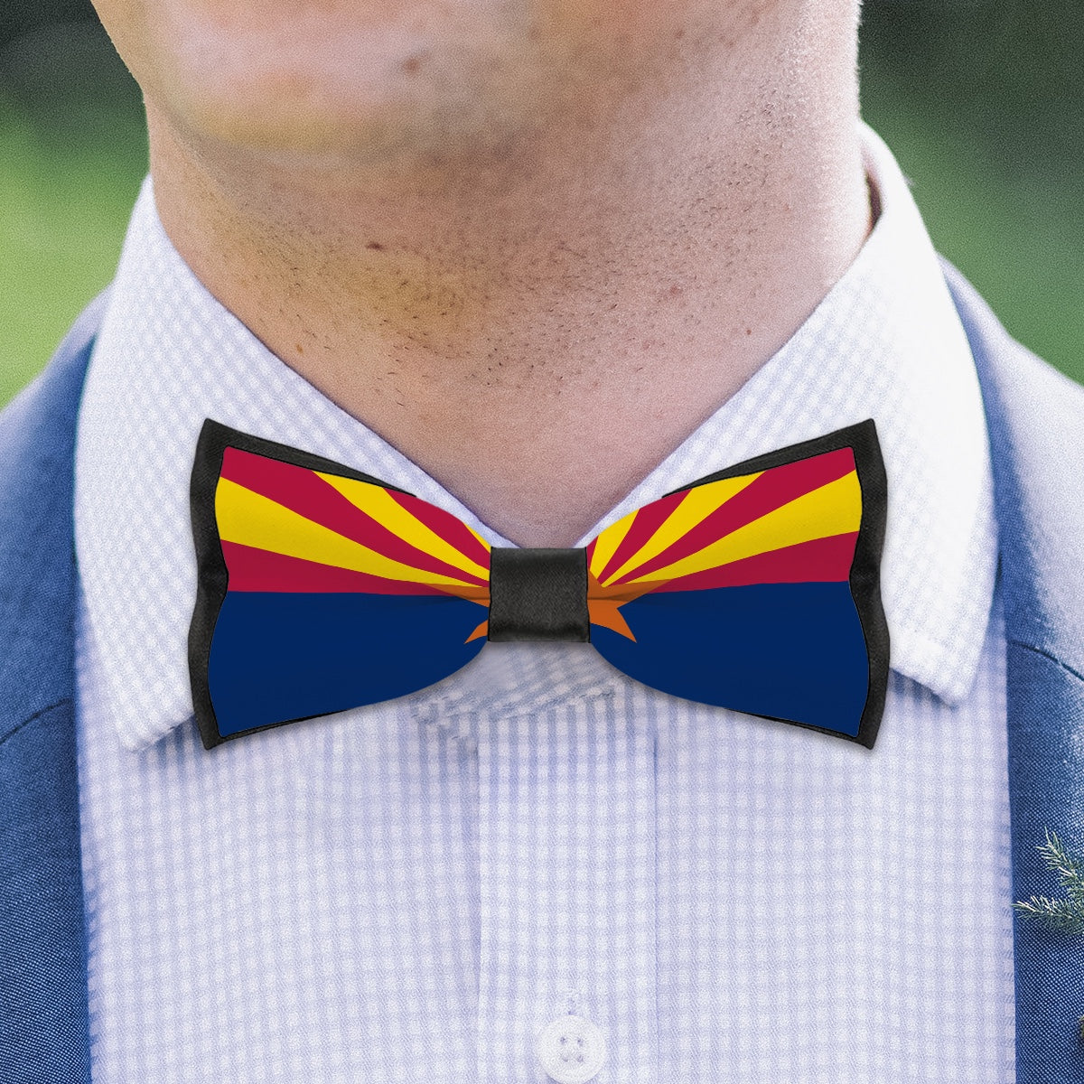 Man wearing [Brand] bow tie with Arizona flag design.