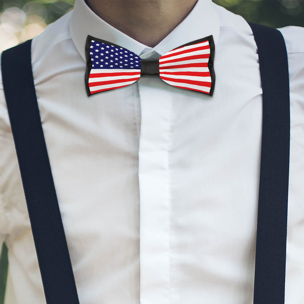 White shirt, American flag bow tie, [Brand], black suspenders.