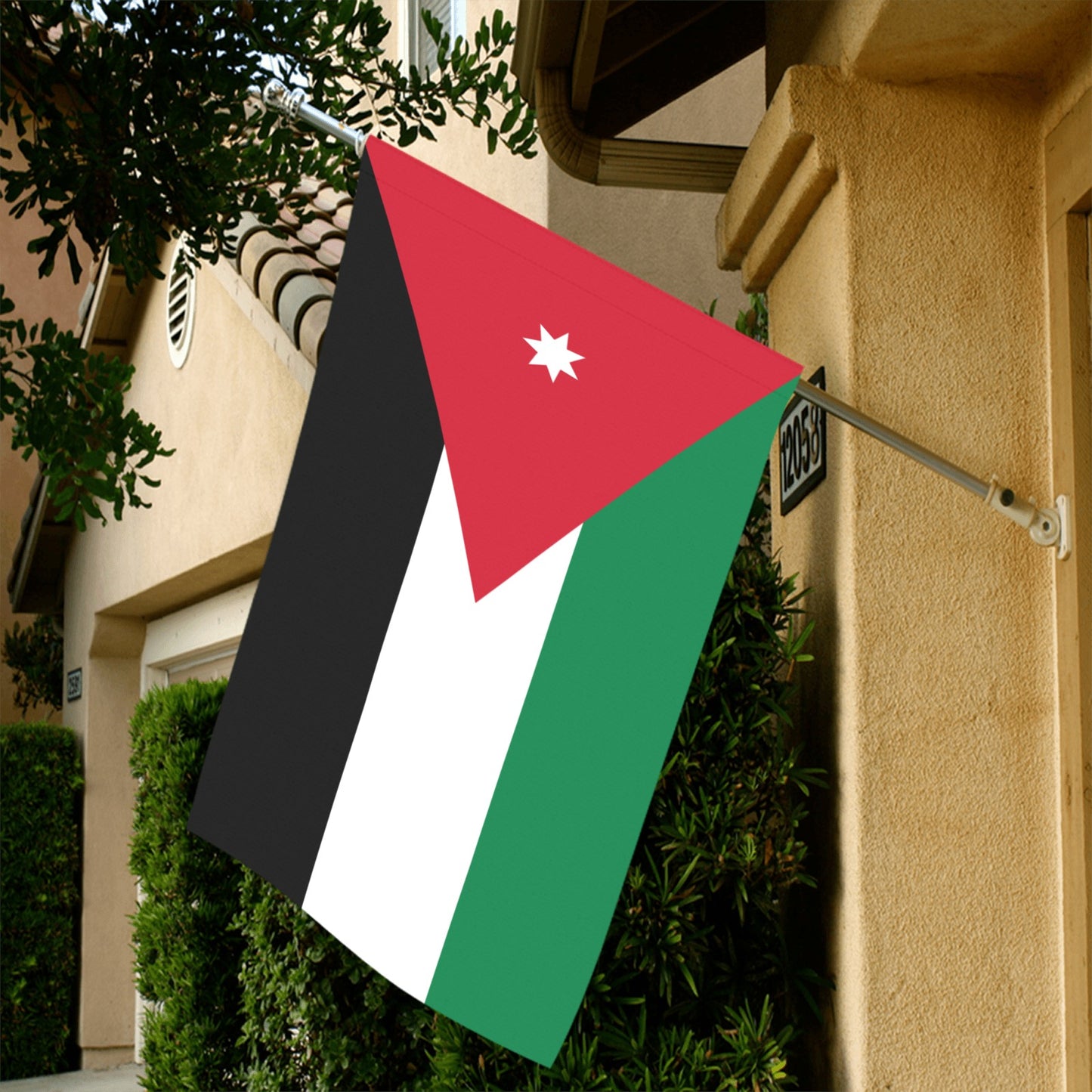 Jordanian flag displayed outside beige building, Luv My Flag.