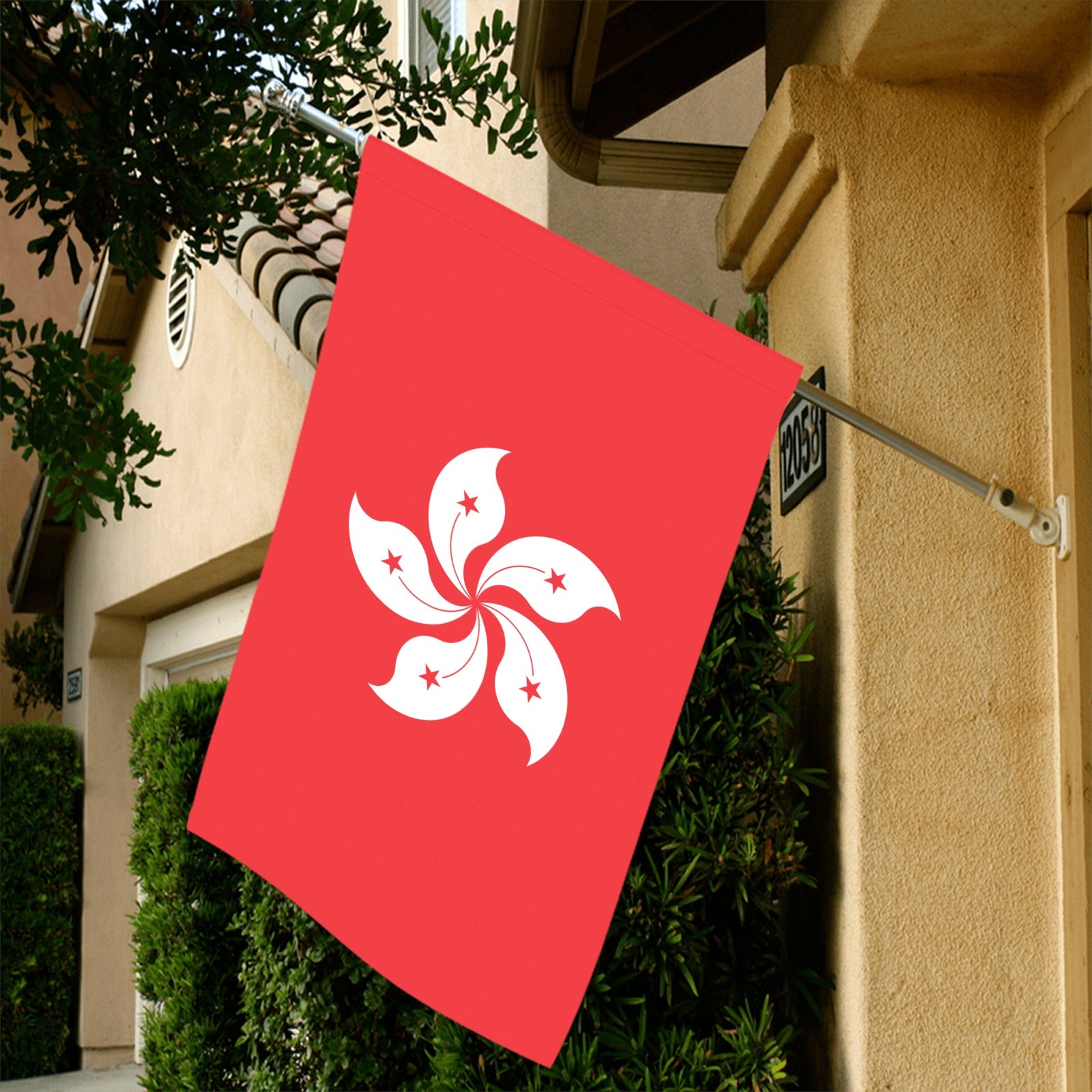 Red flag with white flower displayed outside home, Luv My Flag.