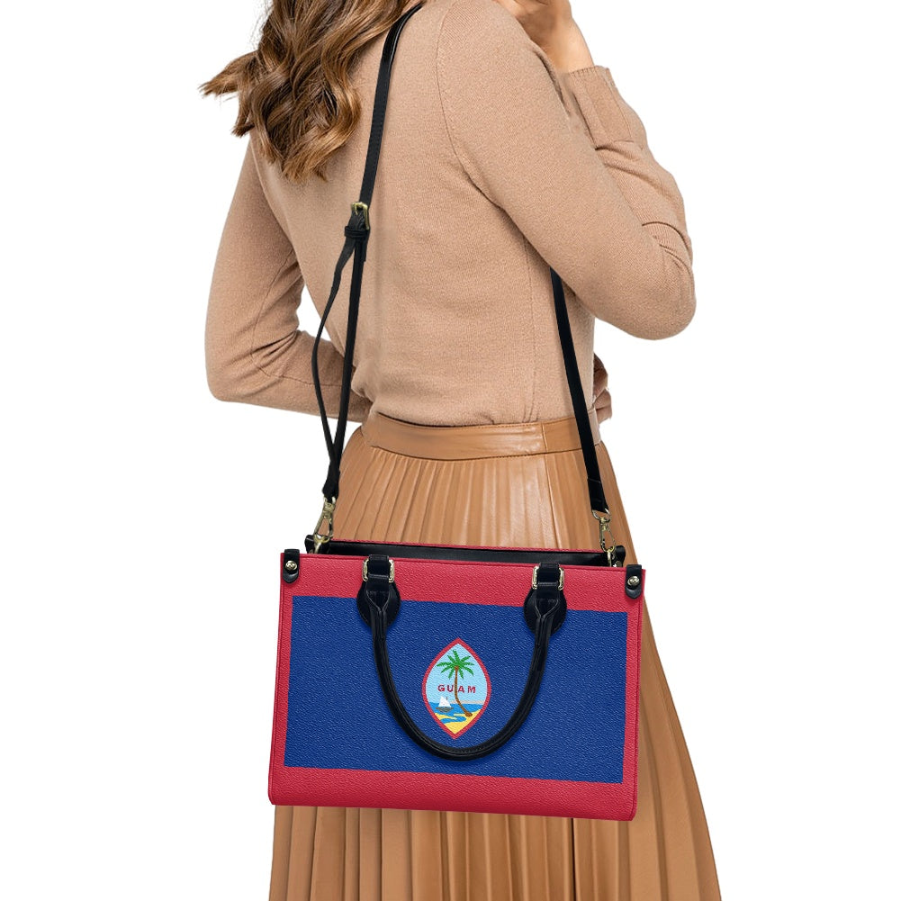 Woman wearing [Brand] handbag with colorful design, Guam emblem.