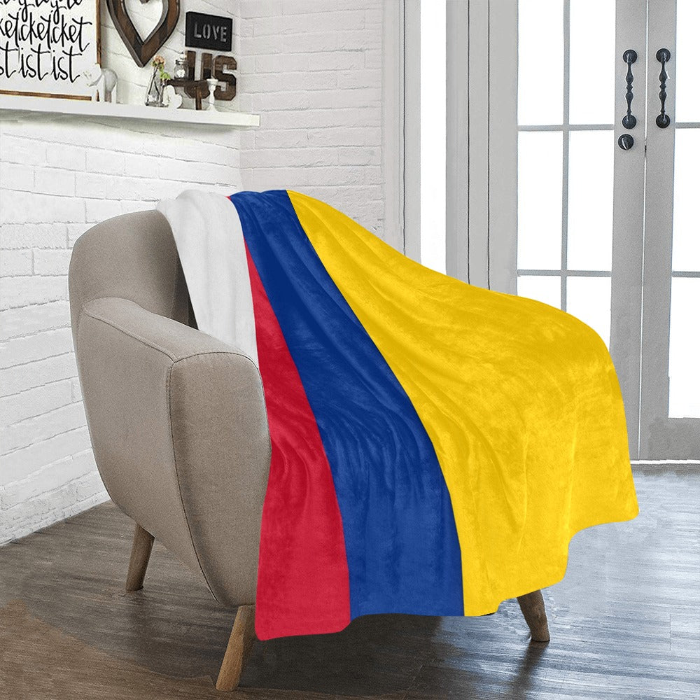 Cozy [Luv My Flag] throw blanket on modern beige chair.