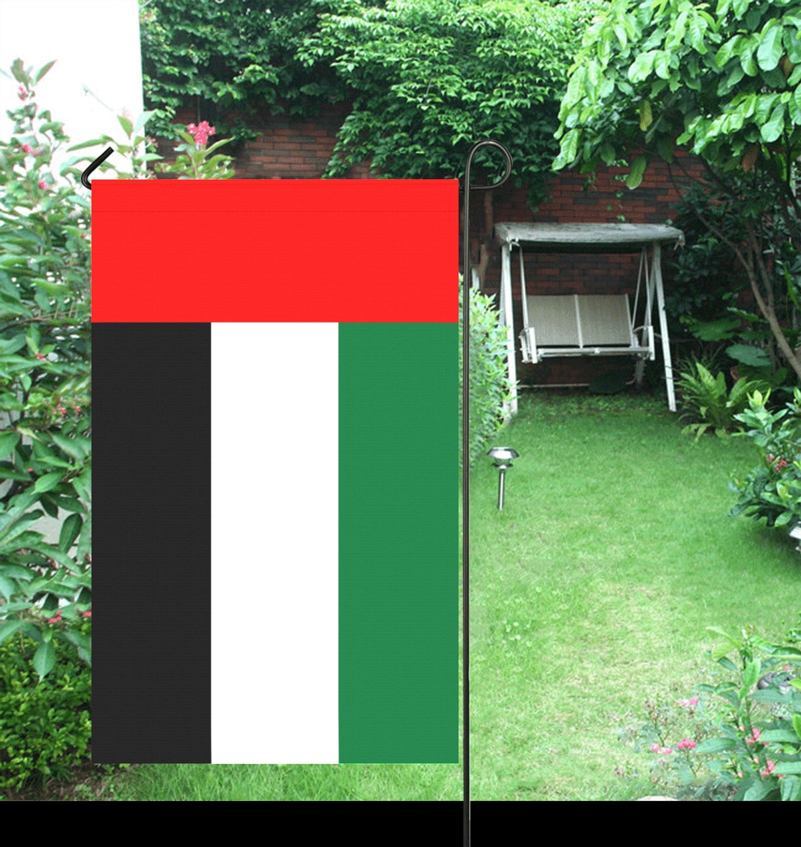 Garden scene featuring Luv My Flag UAE flag displayed.
