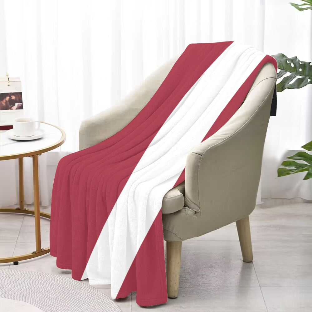 [Luv My Flag] blanket draped over beige armchair, indoors.