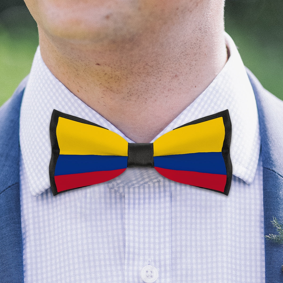 Man wearing [Brand] bow tie with Colombian flag colors.
