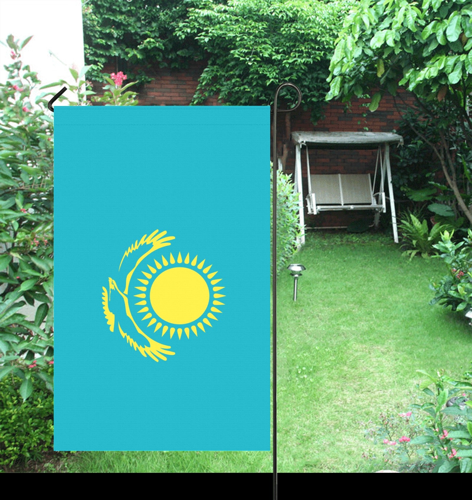 Blue flag with yellow sun design in garden; [Luv My Flag].