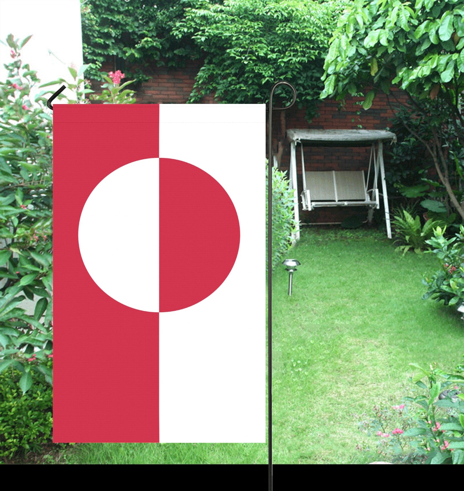 [Luv My Flag] garden flag displayed in lush green garden.