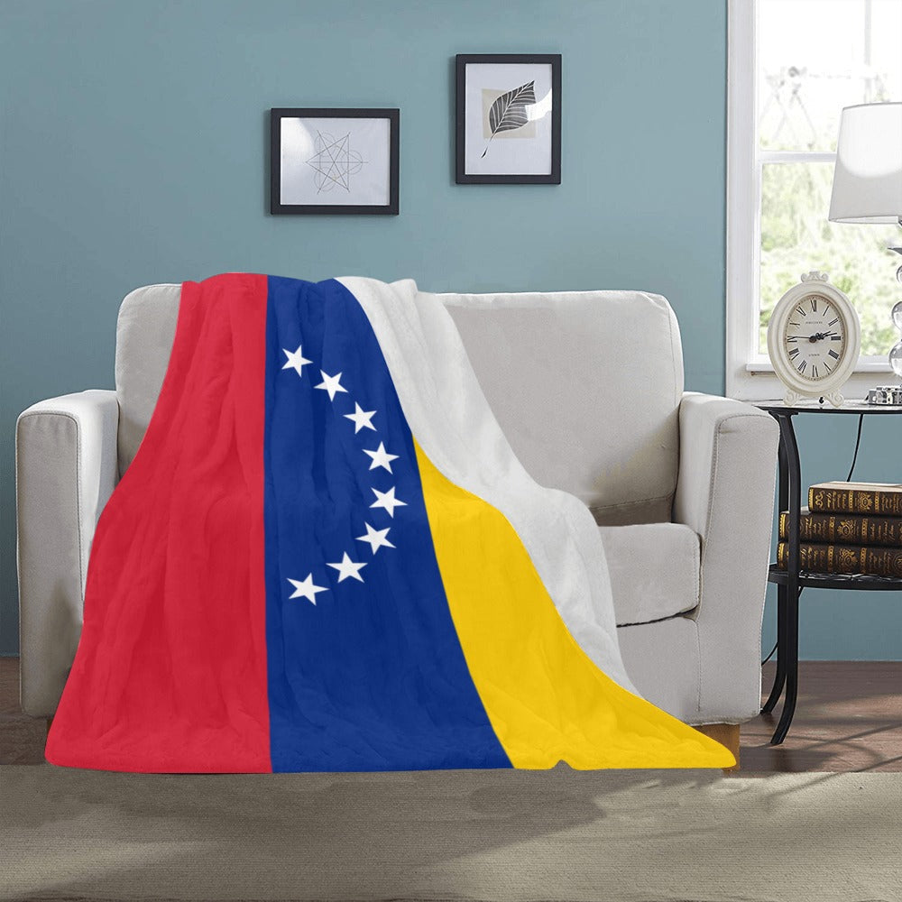 Cozy couch adorned with Luv My Flag Venezuela blanket.