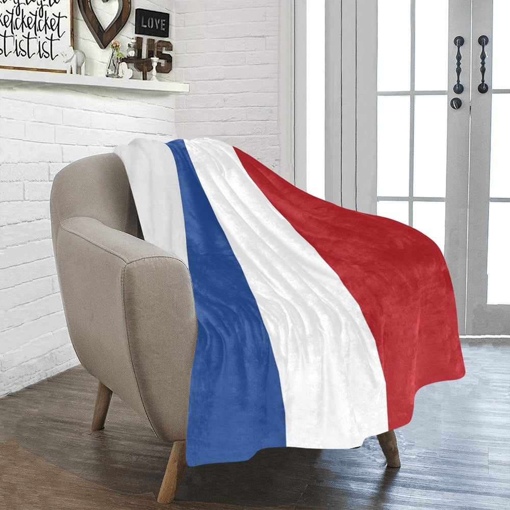 Cozy chair with Luv My Flag tricolor blanket draped.