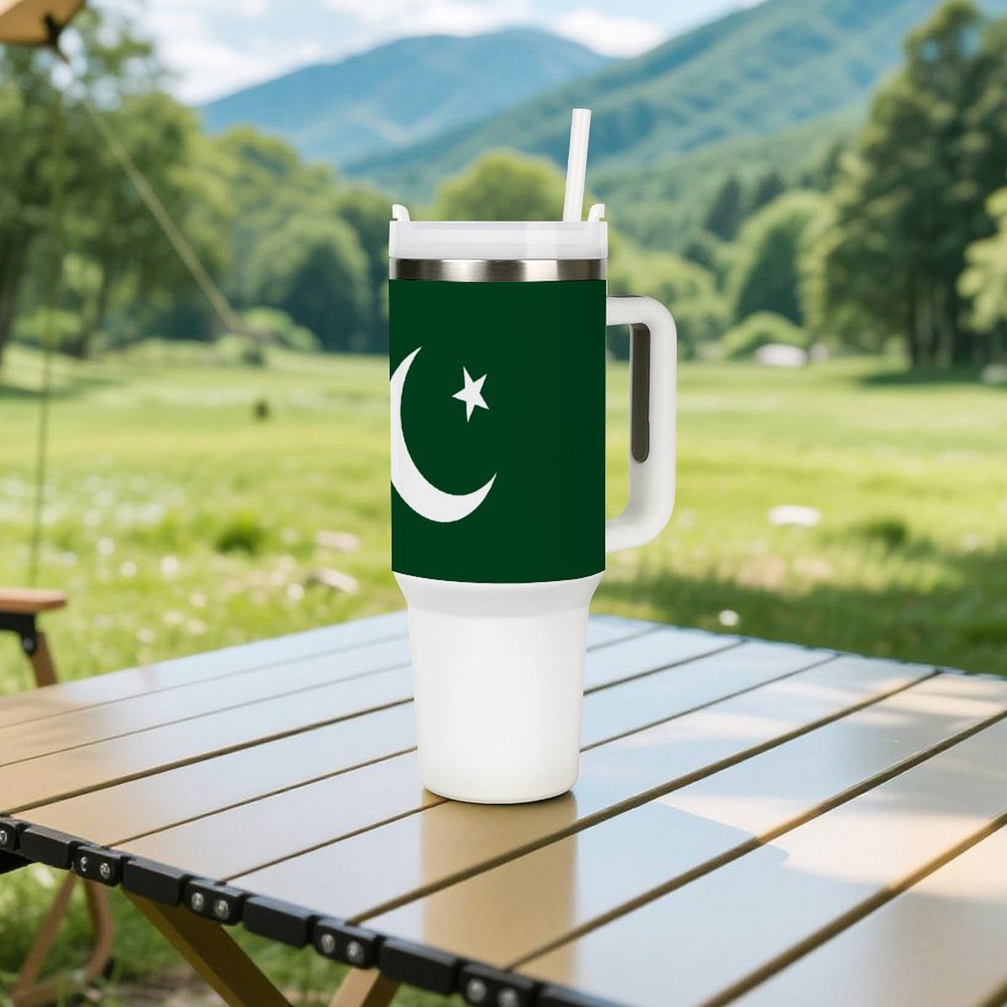 [Brand] travel mug with crescent design on picnic table.