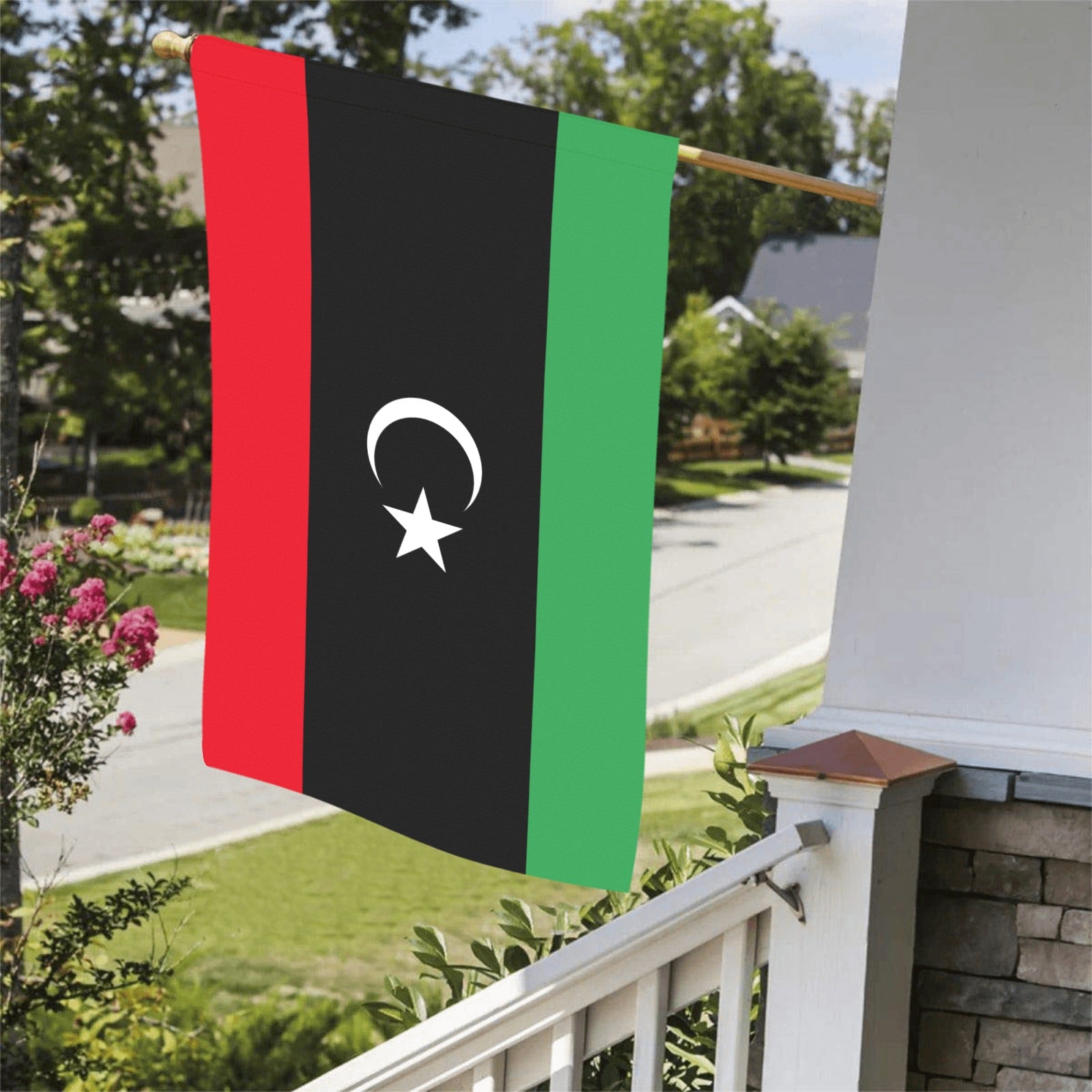 Luv My Flag's Libya flag displayed on suburban porch rail.