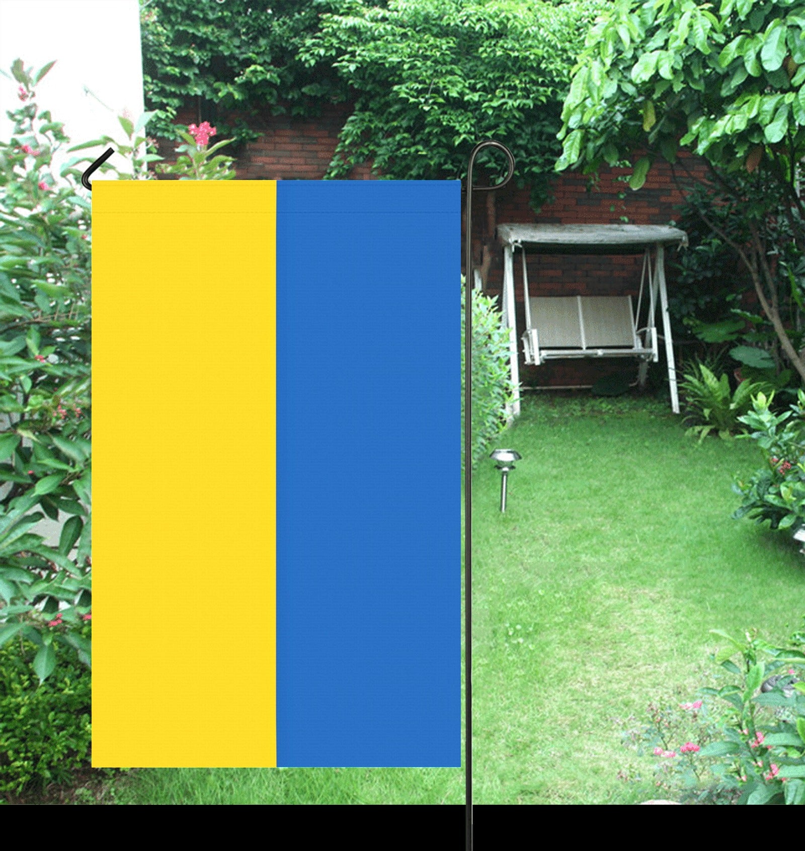 Yellow-blue [Luv My Flag] flag displayed in lush garden.