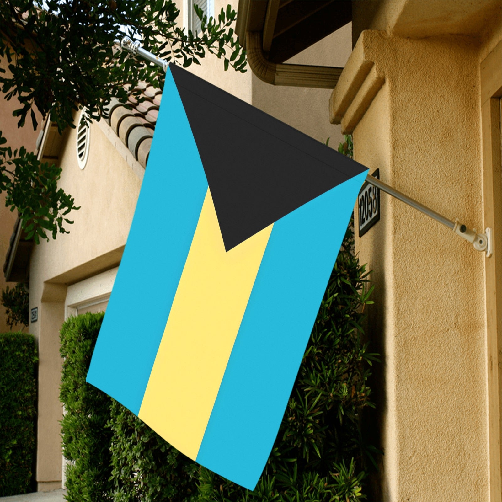 House with Luv My Flag Bahamas flag displayed outside.