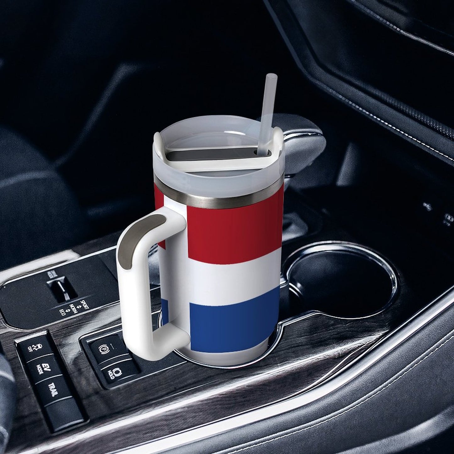 [Brand] mug with flag design in a car's cupholder.
