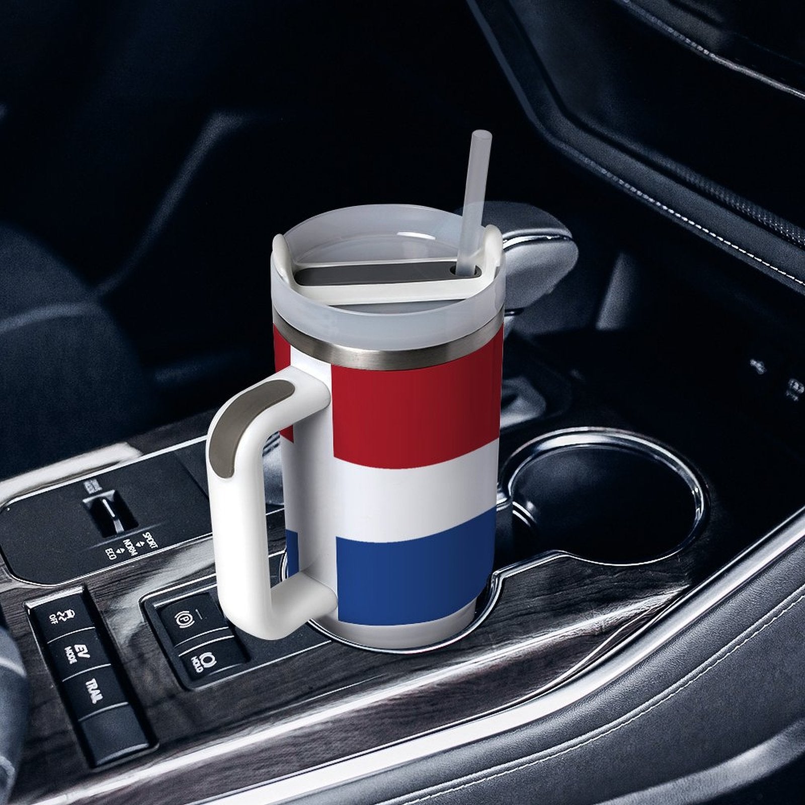 [Brand] mug with flag design in a car's cupholder.