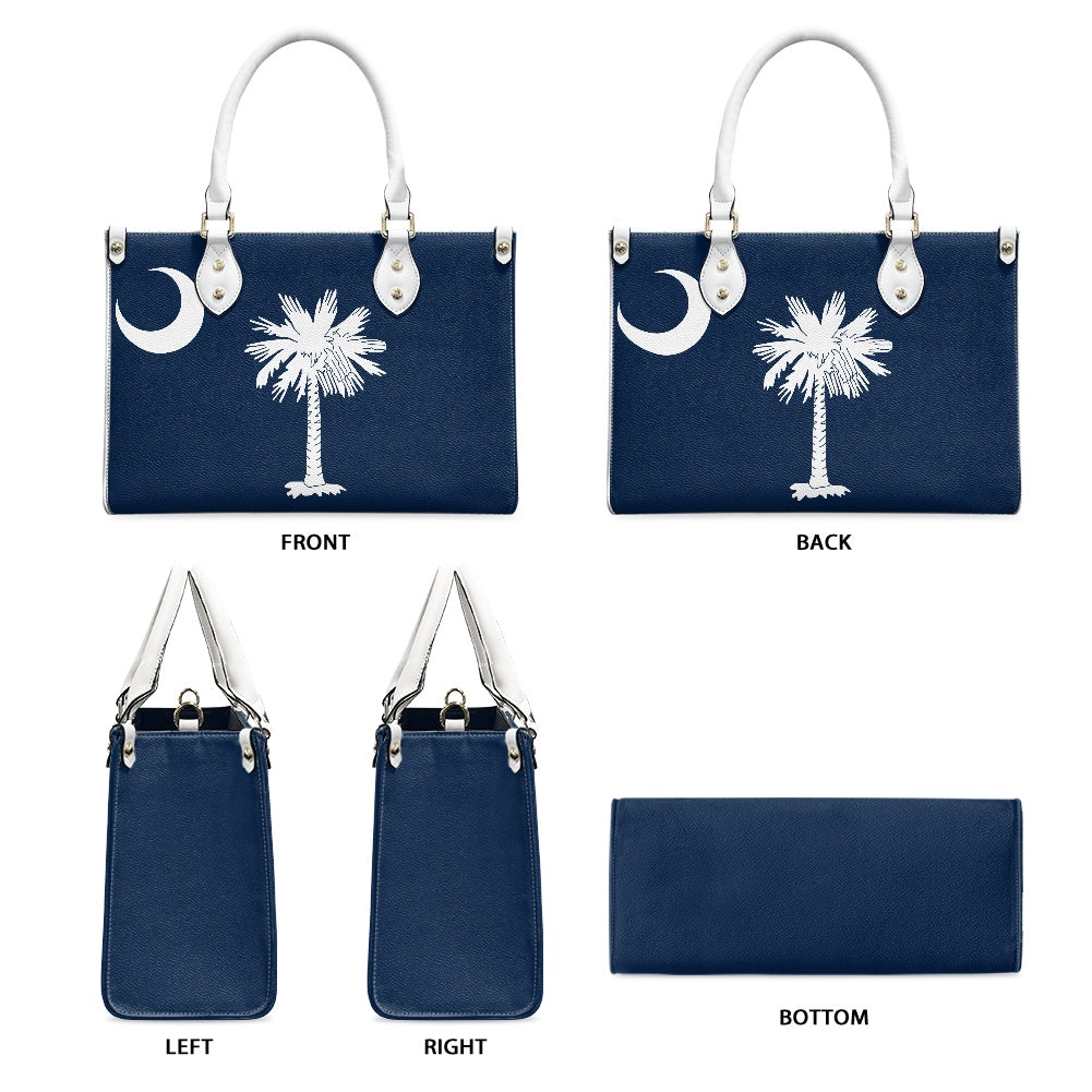 [Brand] navy handbag with palm tree and crescent design.