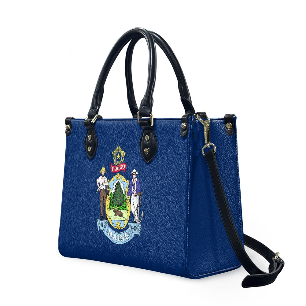 Blue [Brand] handbag with Maine state emblem and straps.