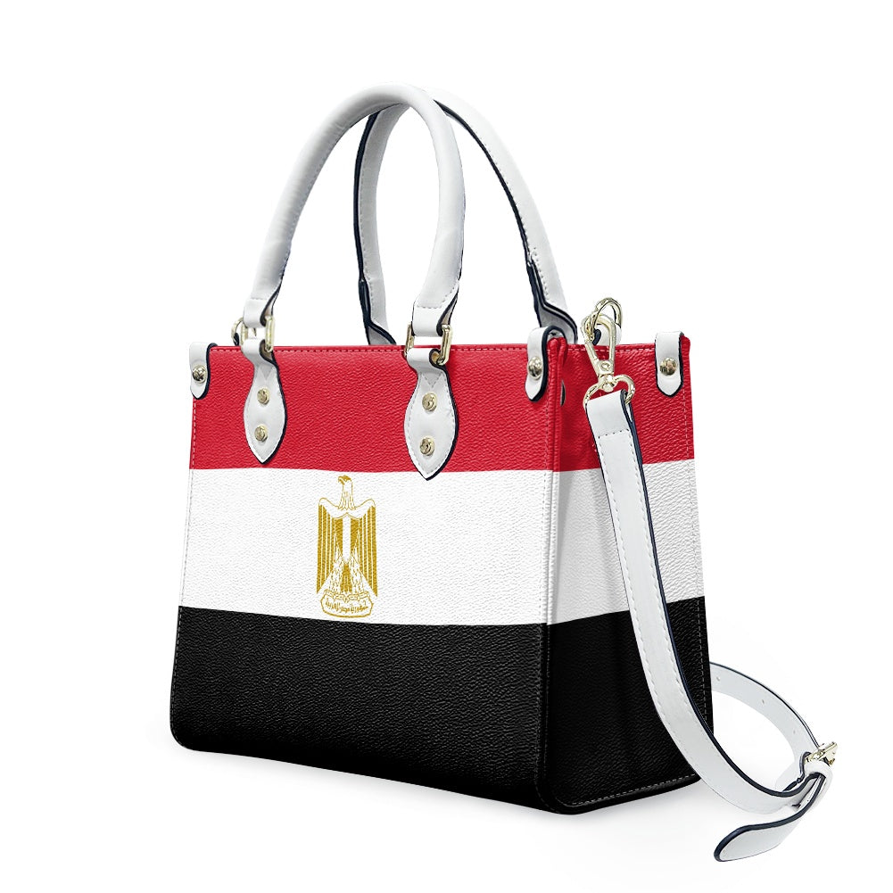 [Brand] handbag featuring Egyptian flag design with detachable strap.