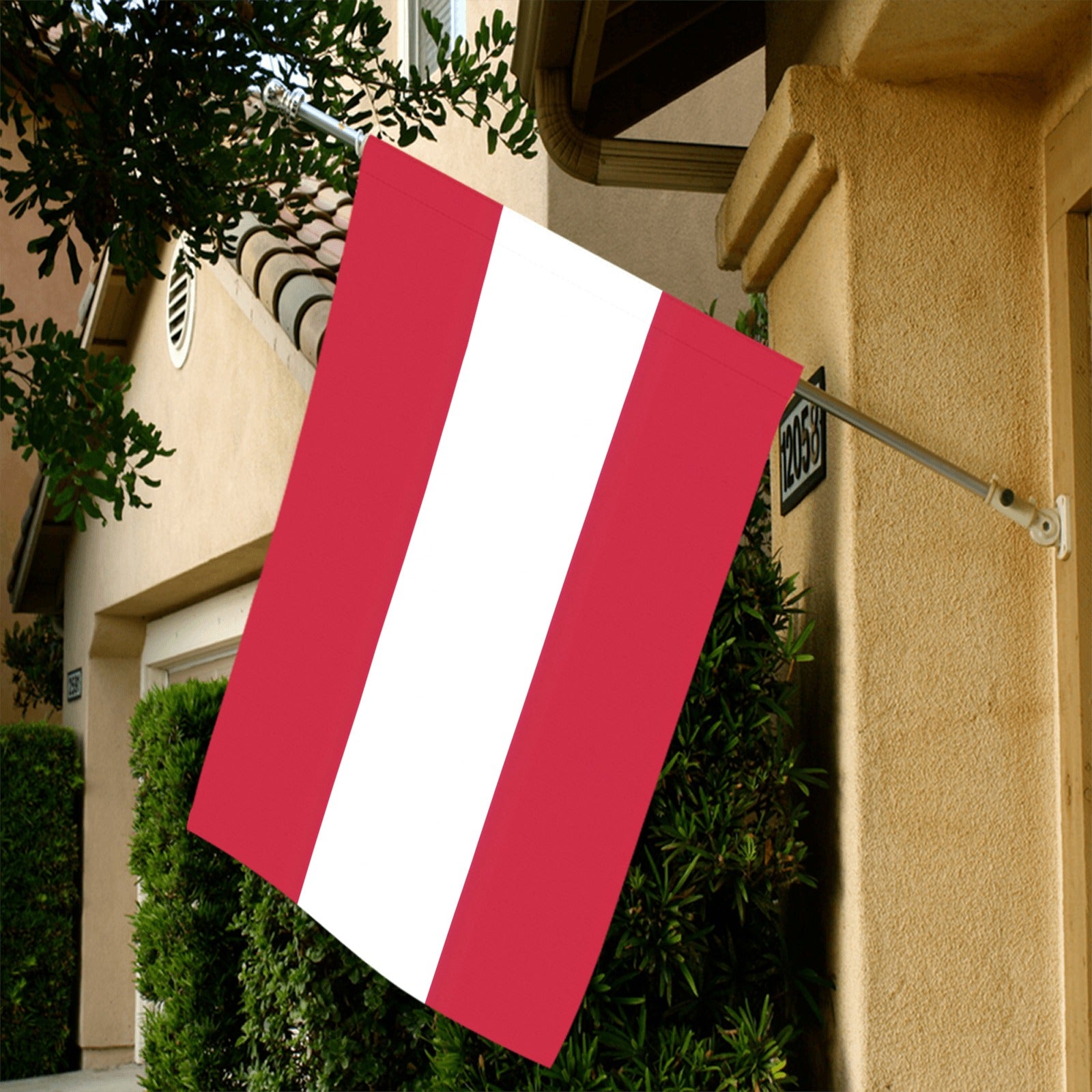 Red and white Luv My Flag hanging on house.