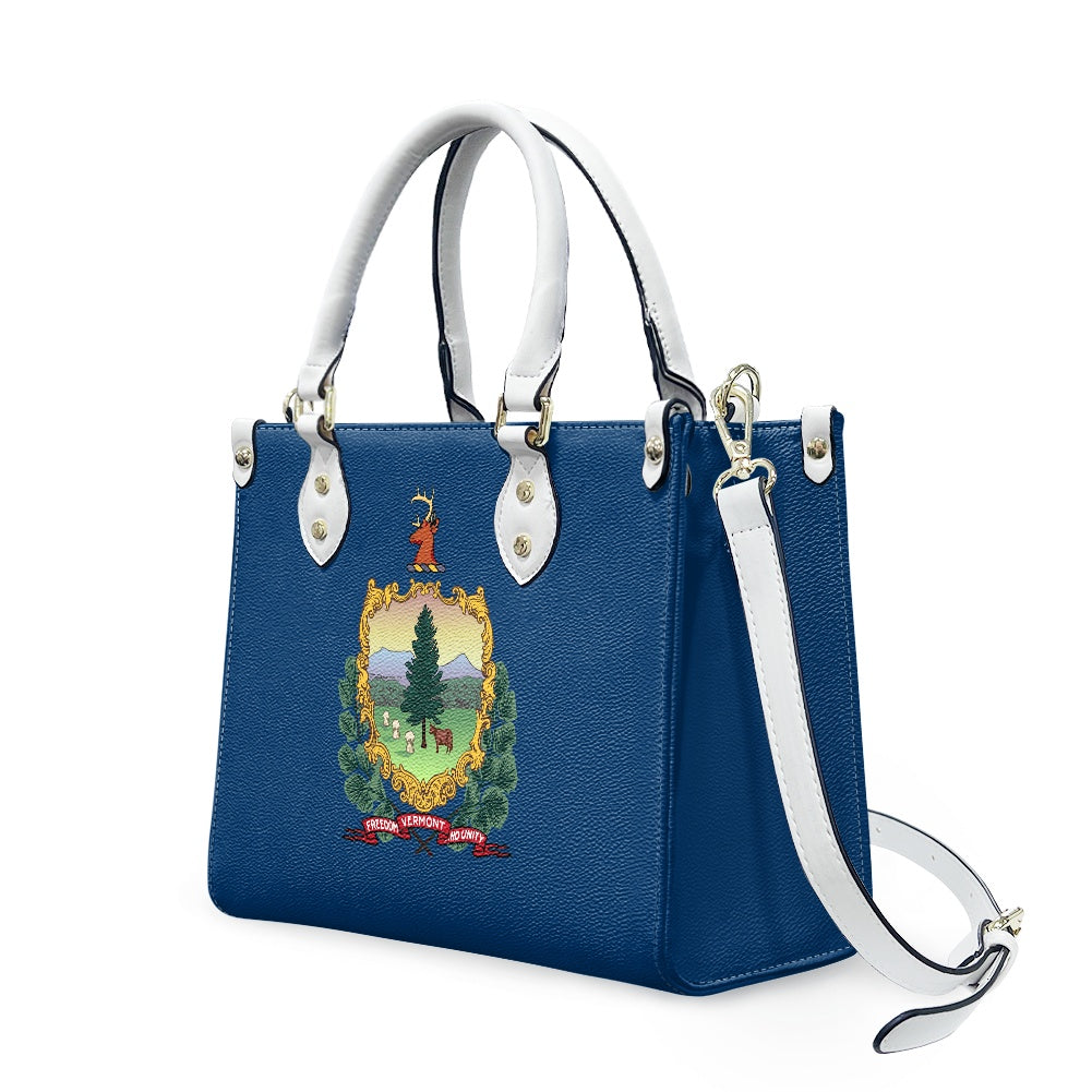 Blue handbag with Vermont emblem, white handles, [Brand].