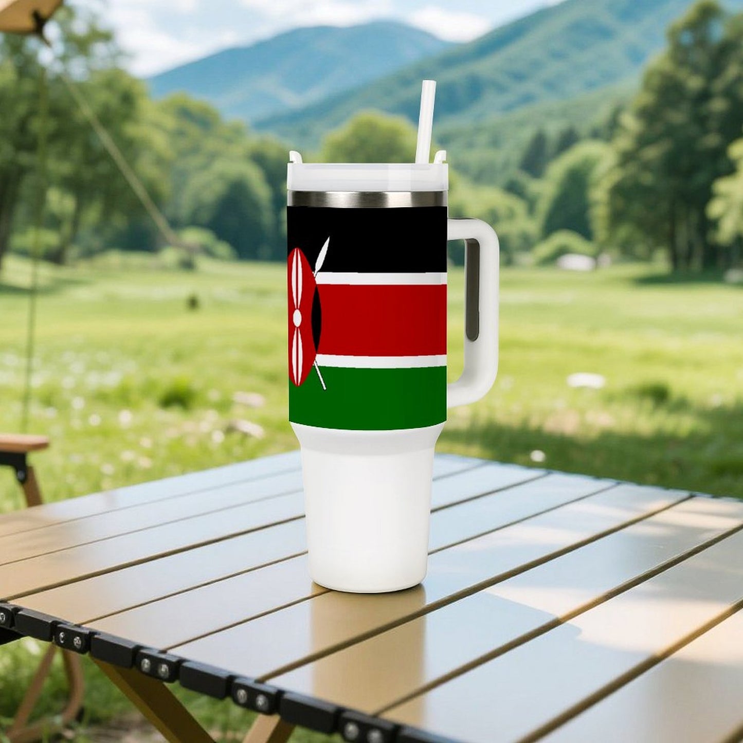 [Brand] tumbler with Kenyan flag, on outdoor table, mountains.