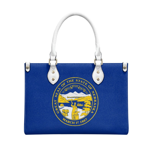 Blue handbag with Nebraska state seal, white handles, [Brand].