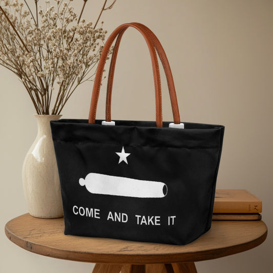 Black [Brand] tote bag with "Come and Take It" print.