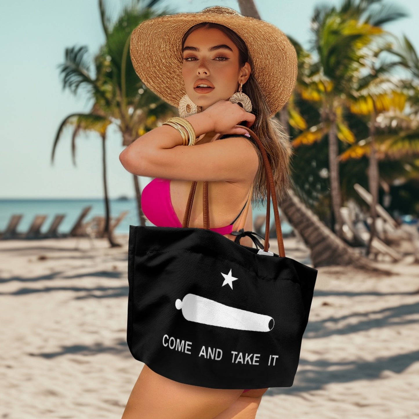 Woman on beach holding [Brand] tote bag under palm trees.