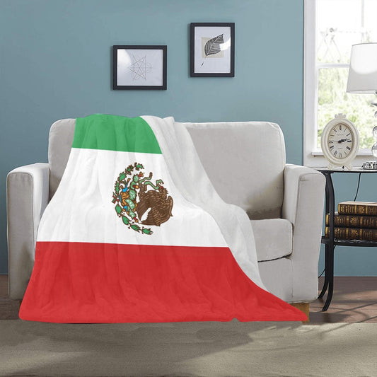 "Luv My Flag blanket displaying Mexican flag on couch."