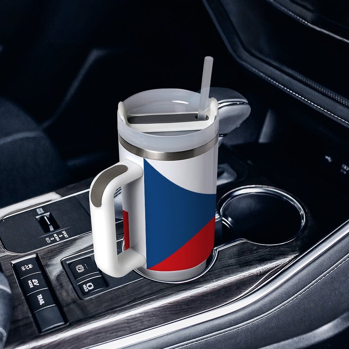 [Brand] travel mug with handle in a car cupholder.