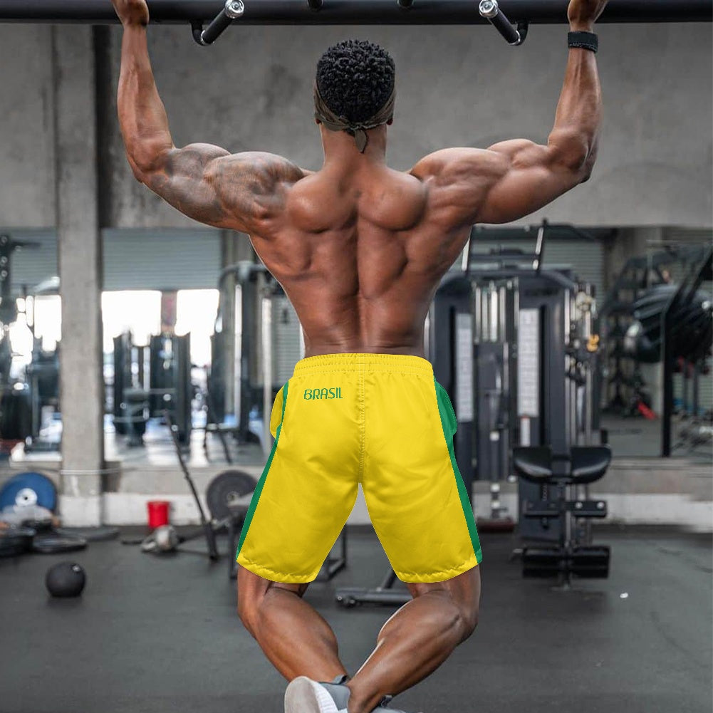 Back view of yellow and green Brazil flag inspired beach shorts with Brasil text, worn by muscular man working out at gym