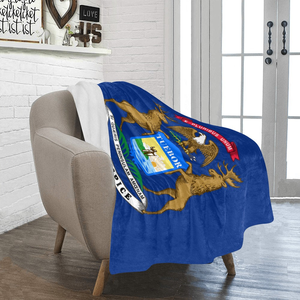 Cozy chair with Luv My Flag Michigan-themed blanket draped.