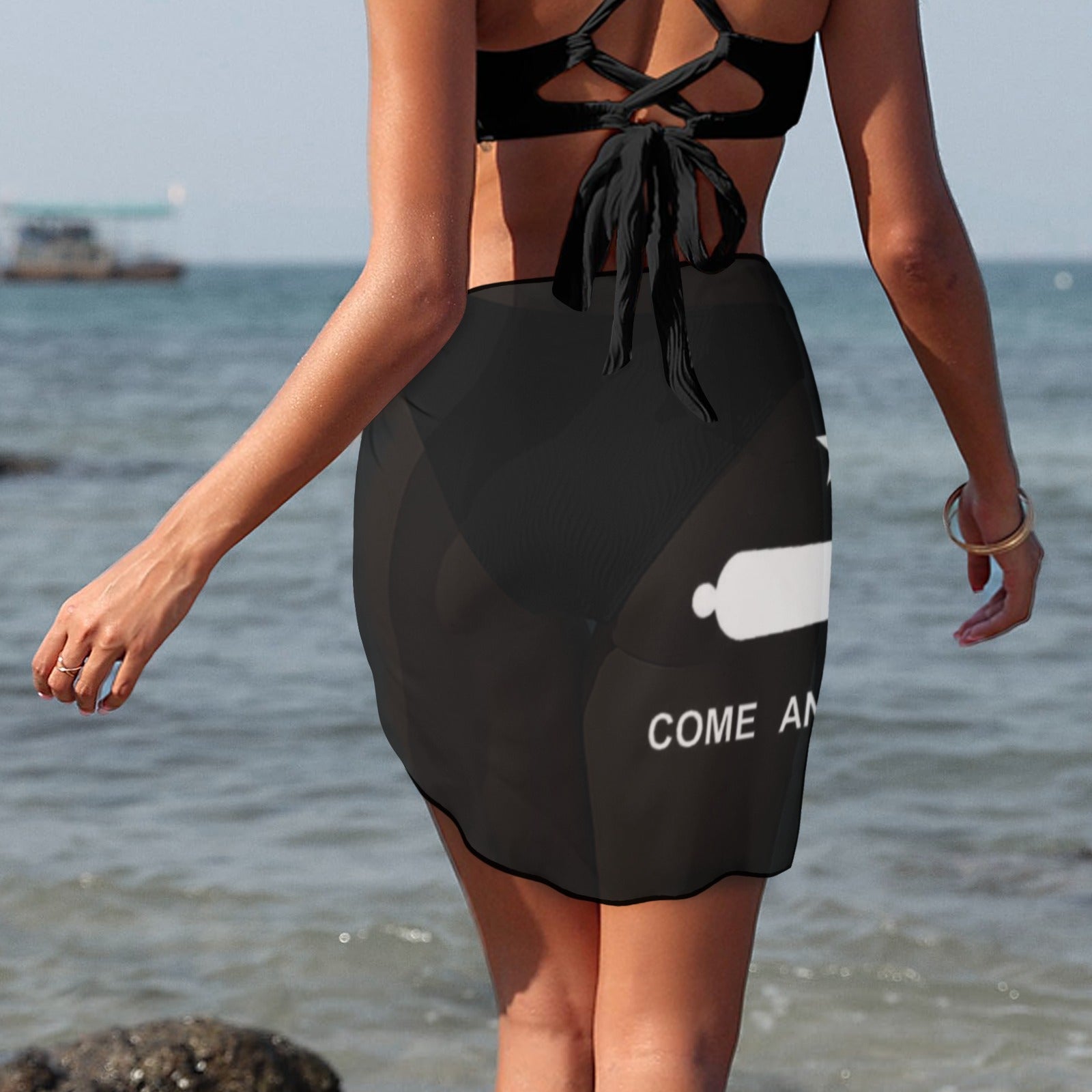 Woman wearing black beachwear sarong, ocean background, Luv My Flag.