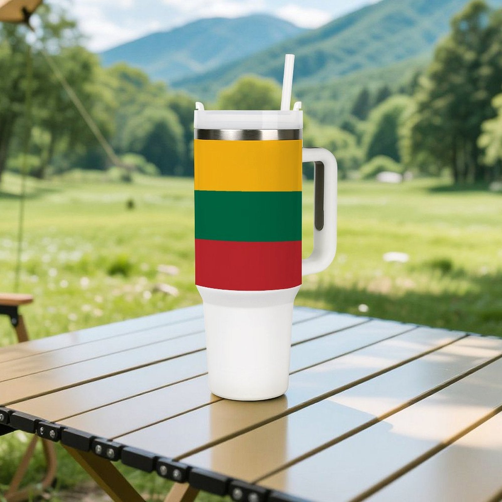 [Brand] travel mug with colorful stripes on picnic table.