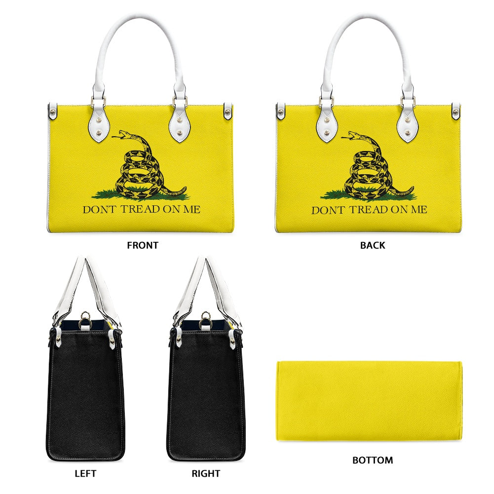 [Brand] yellow handbag with iconic "Don’t Tread On Me" design.