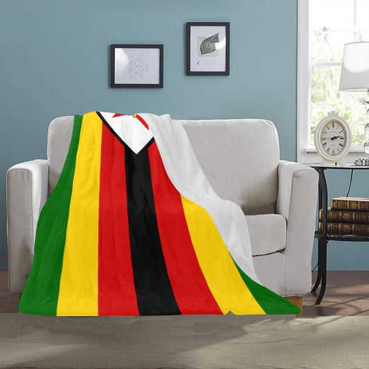 Luv My Flag blanket draped over beige couch, colorful stripes.