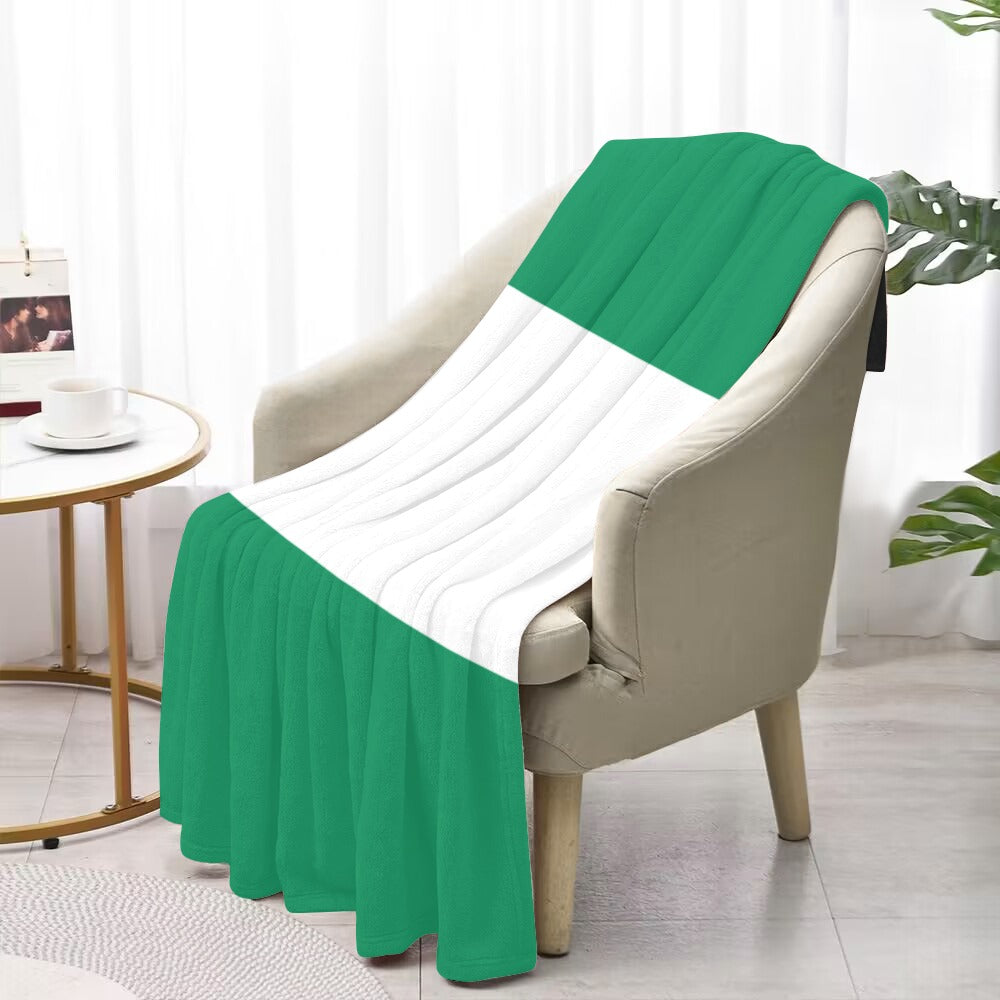 Luv My Flag green-white throw blanket draped on chair.