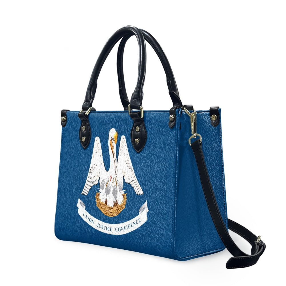 Blue [Brand] handbag with Louisiana pelican emblem and strap.