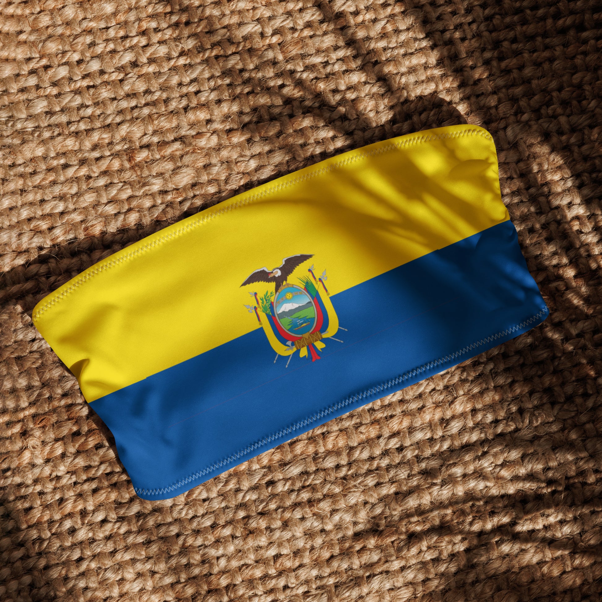 [Brand] Ecuador flag-themed bandana on woven textured surface.