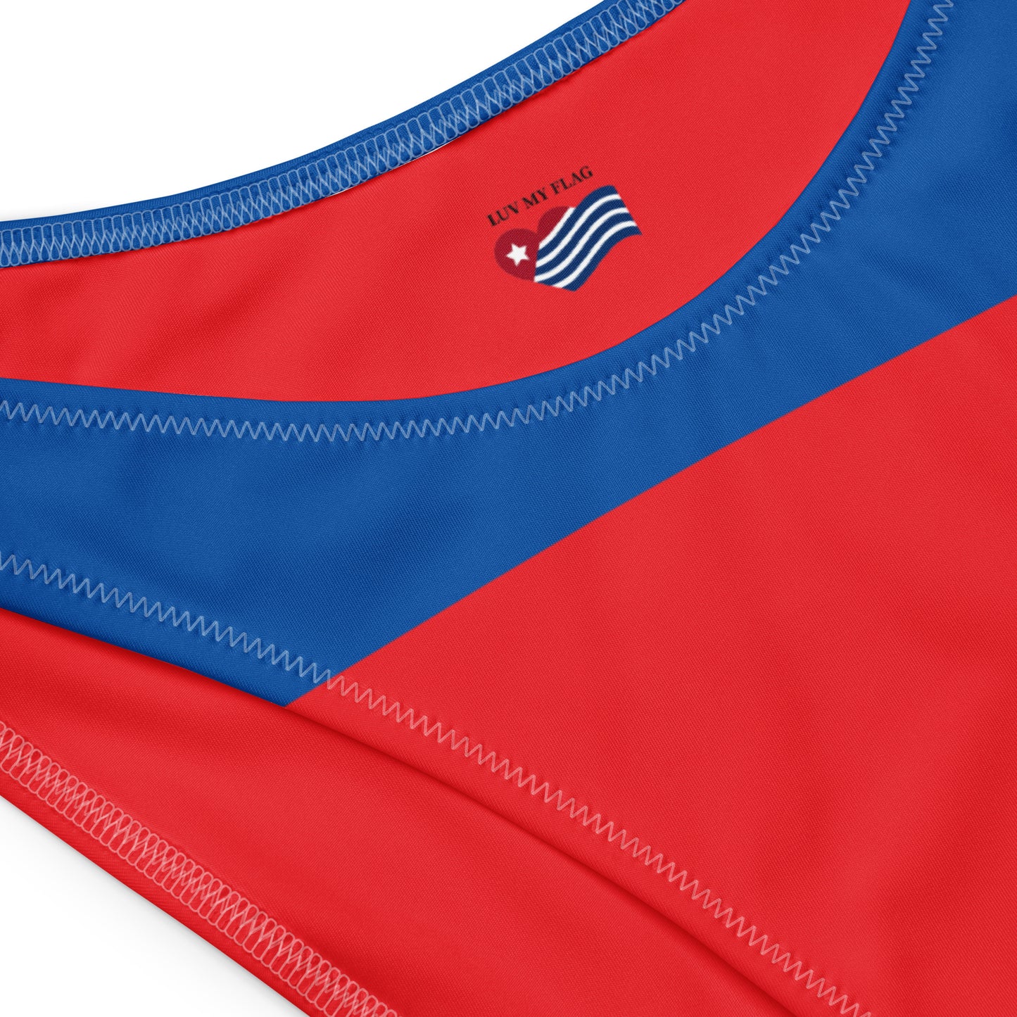Red and blue swimsuit close-up from [Brand], features logo.